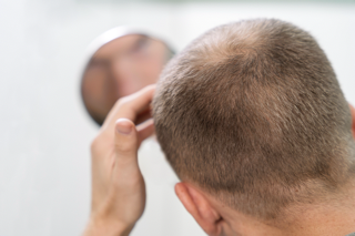 man looking at a mirror